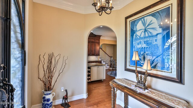 hallway with hardwood / wood-style floors and ornamental molding