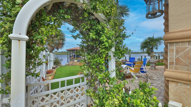 view of yard with a patio area and a water view