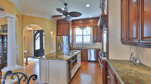 kitchen with dishwasher, backsplash, ornate columns, and light hardwood / wood-style flooring