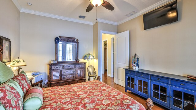 bedroom featuring ornamental molding, ceiling fan, and dark hardwood / wood-style floors