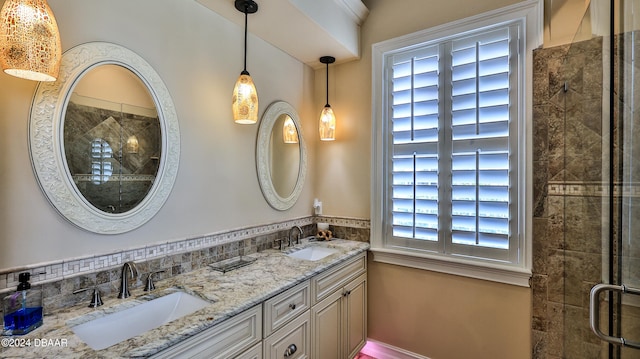 bathroom with vanity and a shower with door