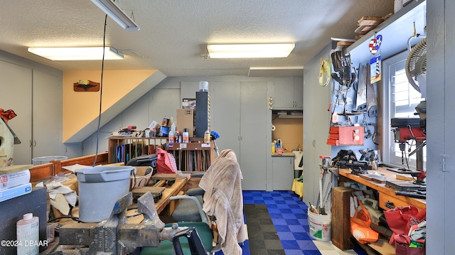 misc room with a workshop area and a textured ceiling