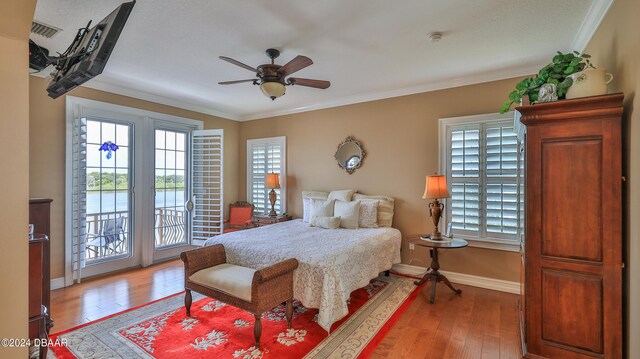 bedroom with crown molding, hardwood / wood-style flooring, ceiling fan, and access to exterior