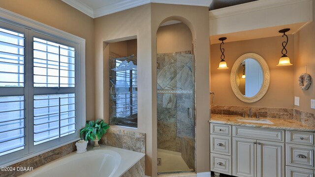 bathroom with shower with separate bathtub, crown molding, and vanity