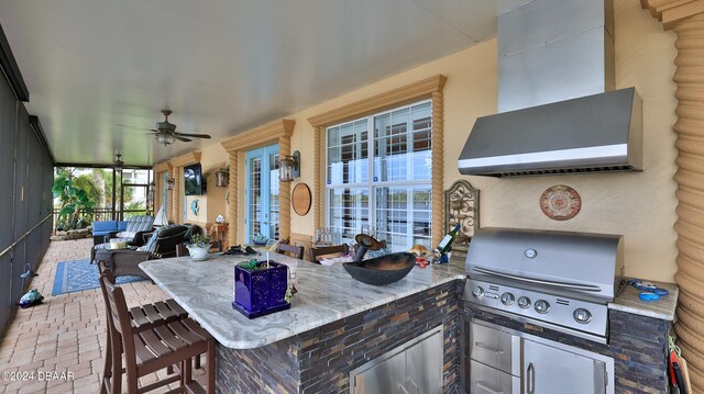 view of patio with ceiling fan and grilling area