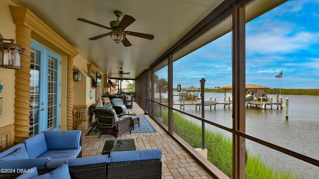 sunroom featuring ceiling fan