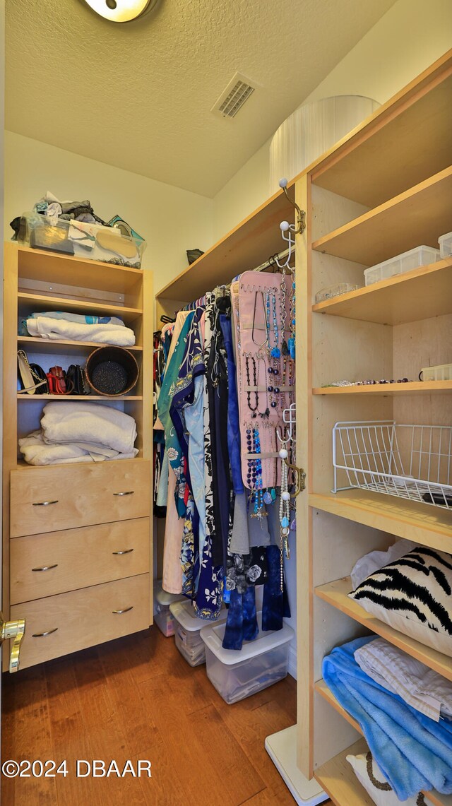 walk in closet featuring dark hardwood / wood-style floors