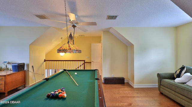 recreation room with ceiling fan, wood-type flooring, a textured ceiling, and pool table