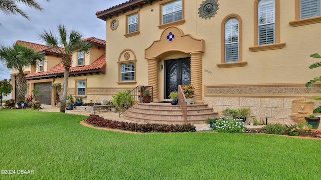 view of front of home with a front lawn and a garage