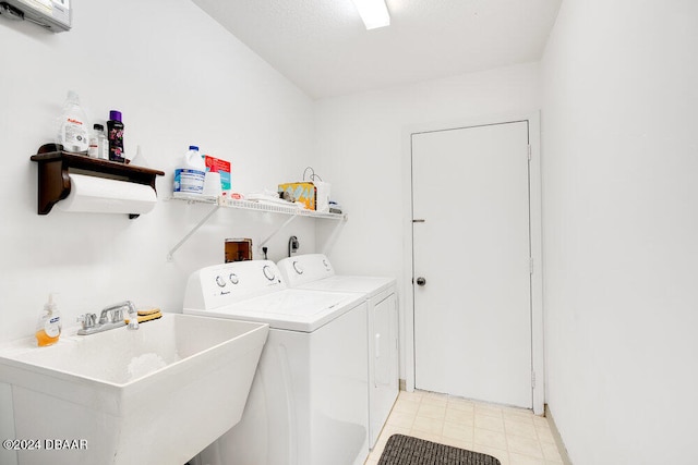 clothes washing area with sink and independent washer and dryer