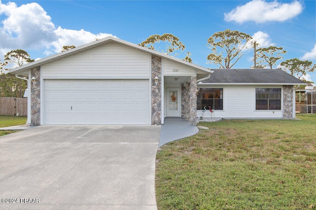 ranch-style home featuring a garage and a front yard