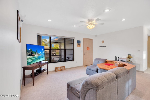 carpeted living room featuring ceiling fan