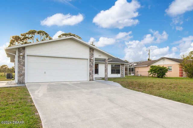 ranch-style house featuring a front lawn, a garage, and cooling unit