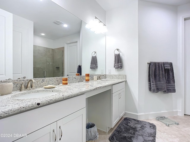 bathroom featuring tile patterned flooring, vanity, and a shower with shower door