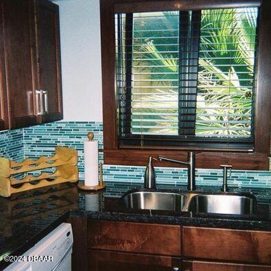 room details featuring sink and decorative backsplash