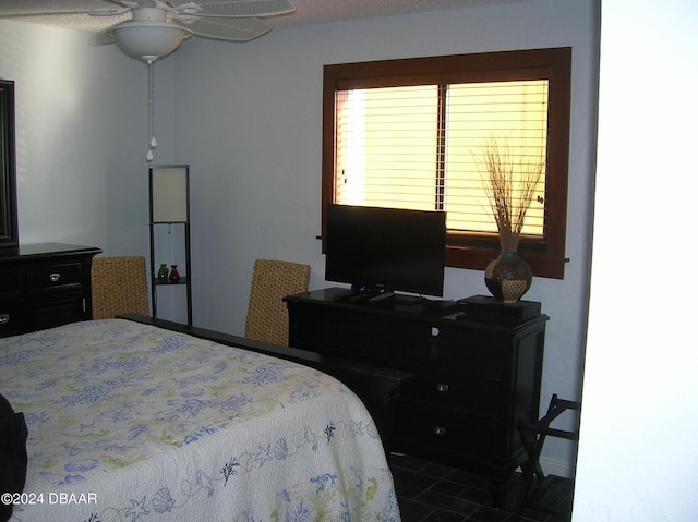 tiled bedroom with ceiling fan