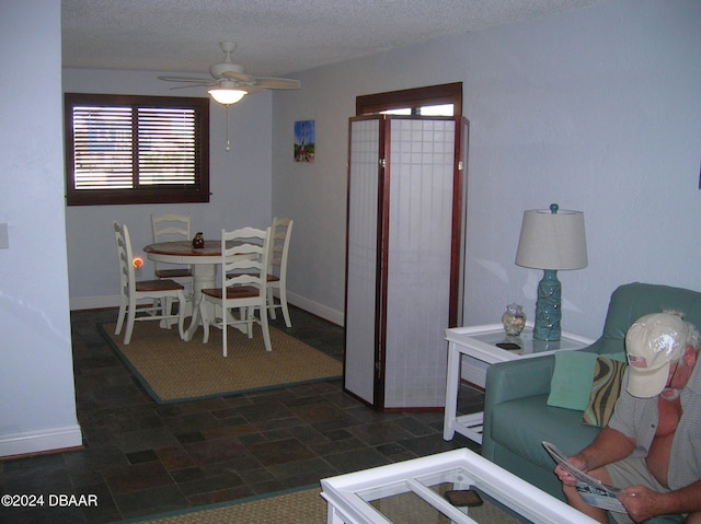 dining space featuring a textured ceiling and ceiling fan