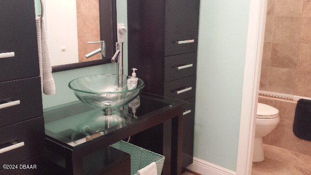 bathroom featuring tile patterned flooring, sink, and toilet