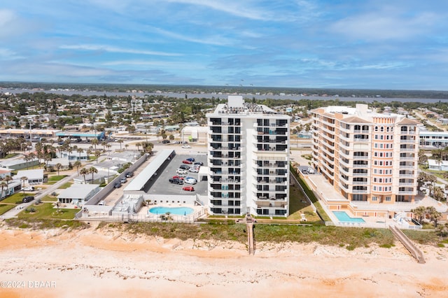 birds eye view of property with a view of the beach and a water view