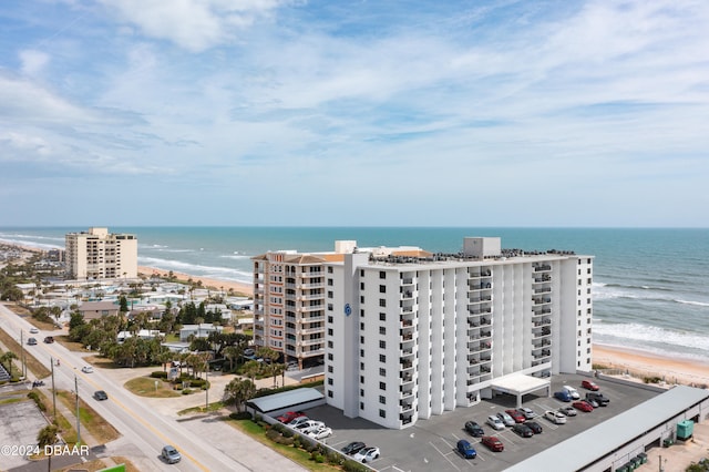 birds eye view of property with a view of the beach and a water view