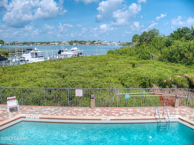 520 S Peninsula Ave Unit 2D7, New Smyrna Beach, FL 32169 - view of swimming pool with a water view and a dock
