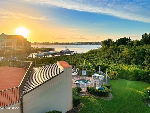 520 S Peninsula Ave Unit 2D7, New Smyrna Beach, FL 32169 - exterior space with a patio, a water view, and a lawn
