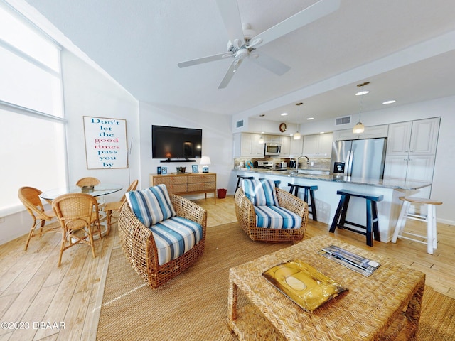 520 S Peninsula Ave Unit 2D7, New Smyrna Beach, FL 32169 - living room with light wood-type flooring, ceiling fan, and sink