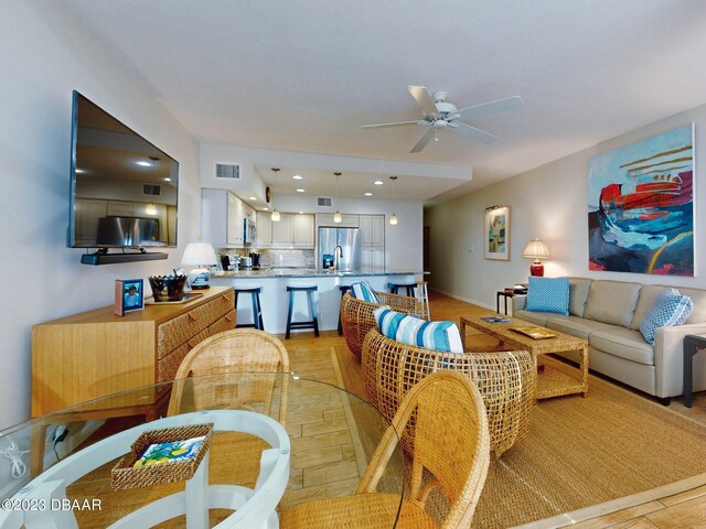 520 S Peninsula Ave Unit 2D7, New Smyrna Beach, FL 32169 - dining room with light hardwood / wood-style floors, sink, and ceiling fan