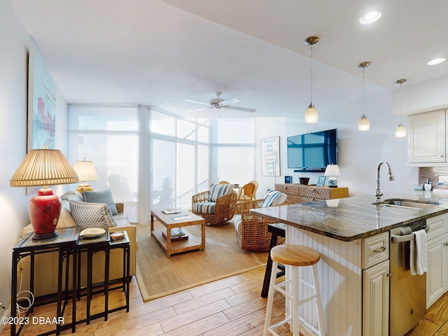 520 S Peninsula Ave Unit 2D7, New Smyrna Beach, FL 32169 - kitchen featuring dishwasher, light hardwood / wood-style flooring, sink, and floor to ceiling windows