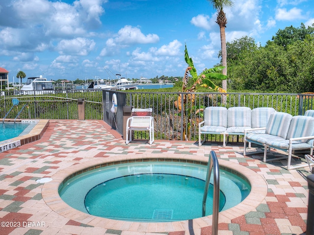 520 S Peninsula Ave Unit 2D7, New Smyrna Beach, FL 32169 - view of pool with an in ground hot tub and a patio area