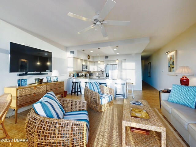 520 S Peninsula Ave Unit 2D7, New Smyrna Beach, FL 32169 - living room with ceiling fan and light hardwood / wood-style flooring