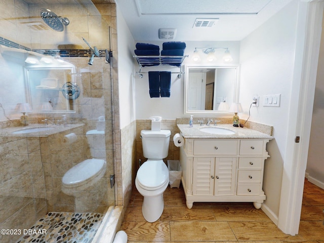 520 S Peninsula Ave Unit 2D7, New Smyrna Beach, FL 32169 - bathroom featuring toilet, vanity, wood-type flooring, and walk in shower