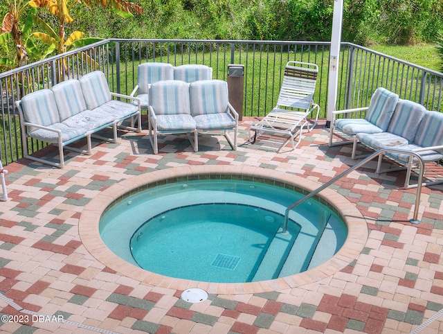 520 S Peninsula Ave Unit 2D7, New Smyrna Beach, FL 32169 - view of swimming pool featuring a patio, a yard, and an in ground hot tub