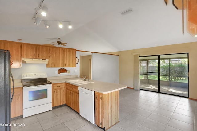 kitchen featuring light tile patterned floors, white appliances, sink, and kitchen peninsula