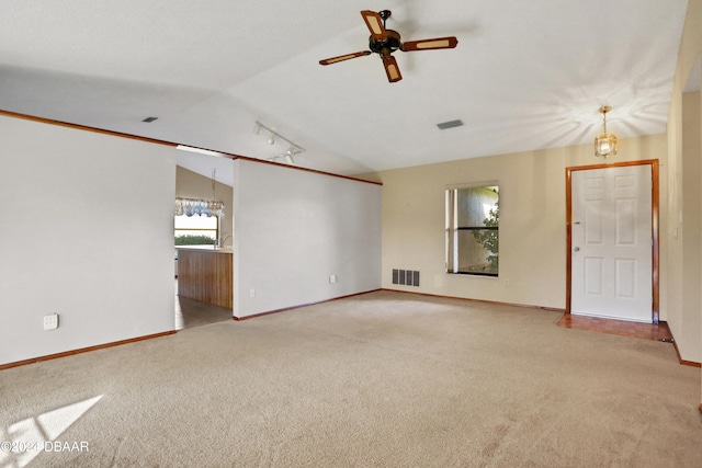 unfurnished room with light colored carpet, ceiling fan with notable chandelier, and vaulted ceiling