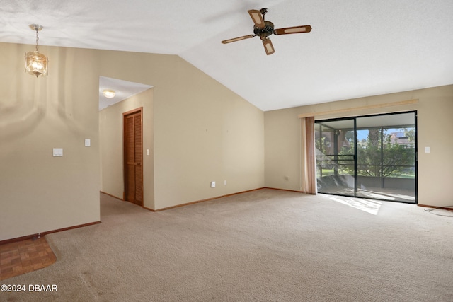 unfurnished room with vaulted ceiling, light colored carpet, and ceiling fan