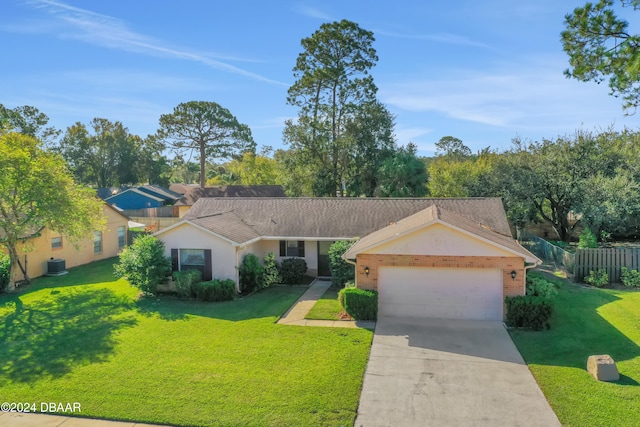 ranch-style home with a garage and a front lawn