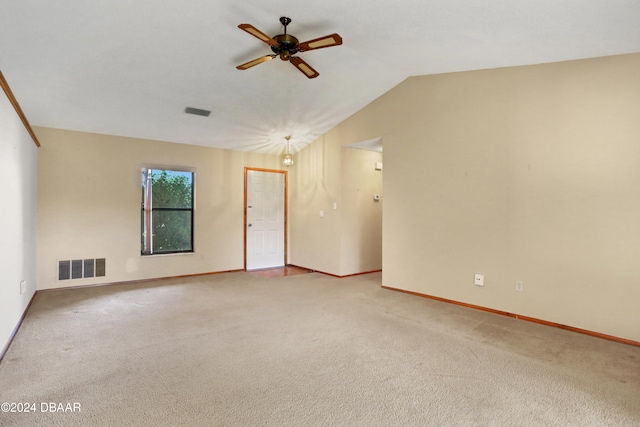 unfurnished room featuring ceiling fan with notable chandelier, vaulted ceiling, and carpet floors