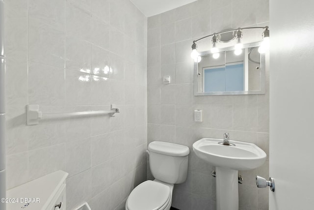 bathroom with backsplash, toilet, and tile walls