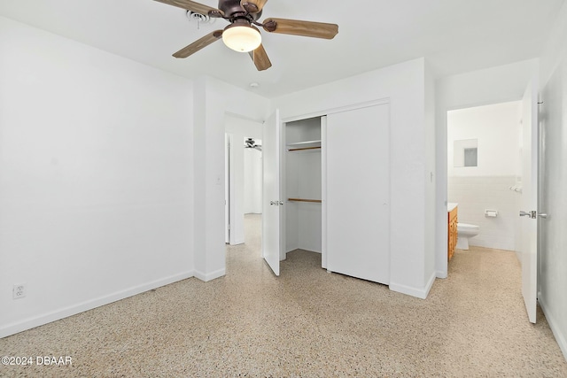 unfurnished bedroom featuring ceiling fan and a closet