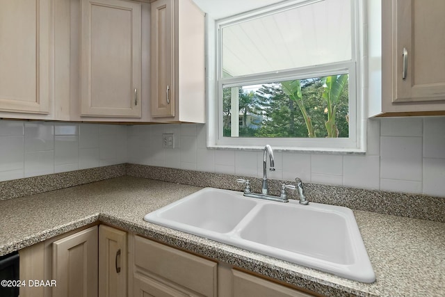 kitchen featuring light brown cabinetry, decorative backsplash, and sink