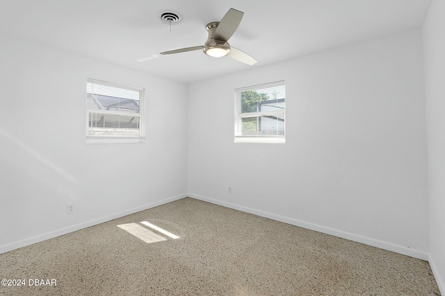 unfurnished room with ceiling fan