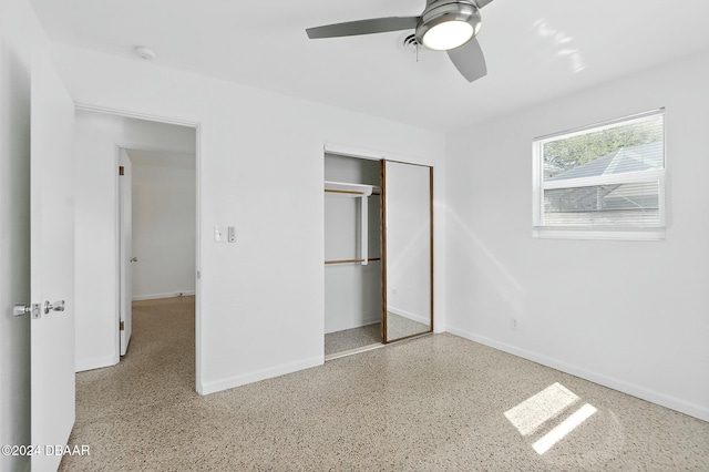 unfurnished bedroom featuring ceiling fan and a closet