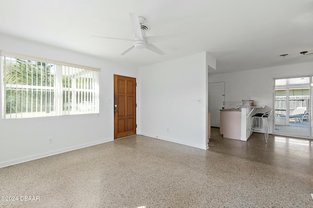 unfurnished room with plenty of natural light and ceiling fan