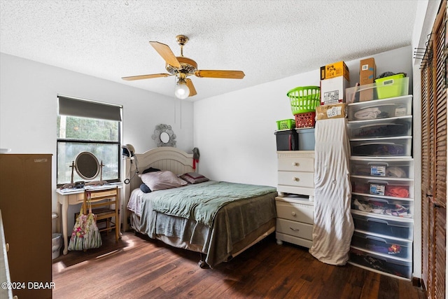 bedroom featuring a textured ceiling, dark hardwood / wood-style flooring, and ceiling fan