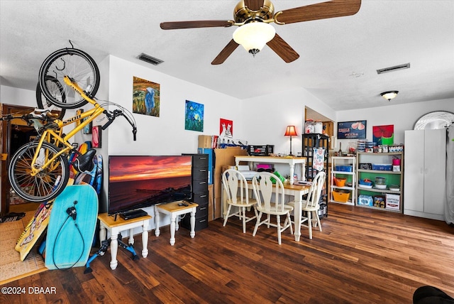 dining area with ceiling fan, a textured ceiling, and dark hardwood / wood-style flooring