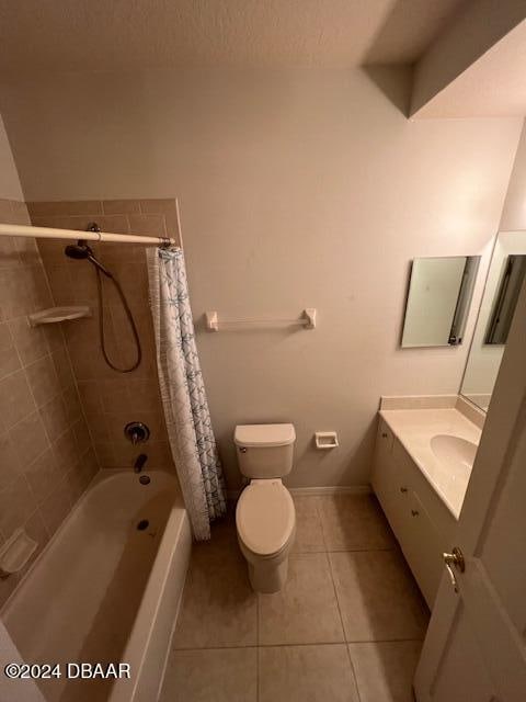 full bathroom with tile patterned floors, vanity, shower / bath combo, and toilet