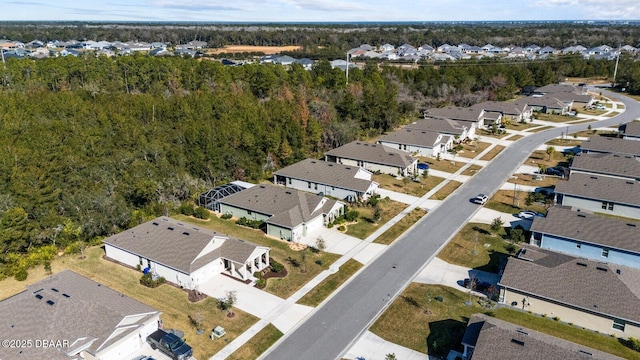 birds eye view of property with a residential view and a view of trees