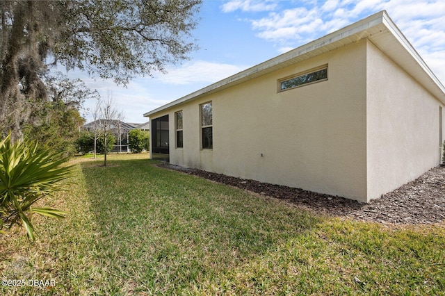 view of property exterior featuring a lawn and stucco siding