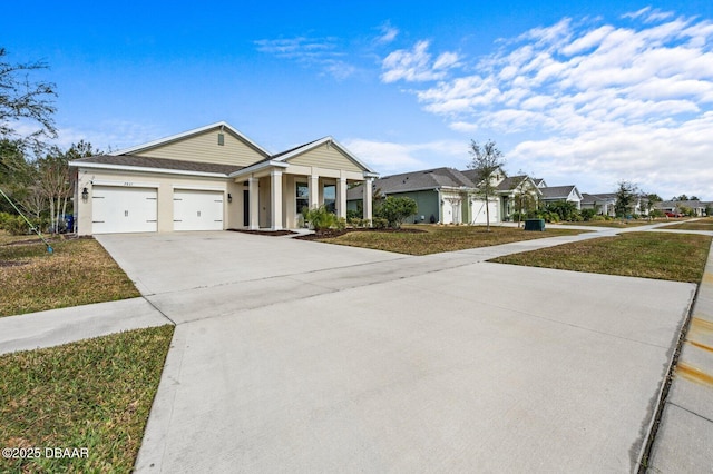 view of front of house with a garage, concrete driveway, and a front lawn